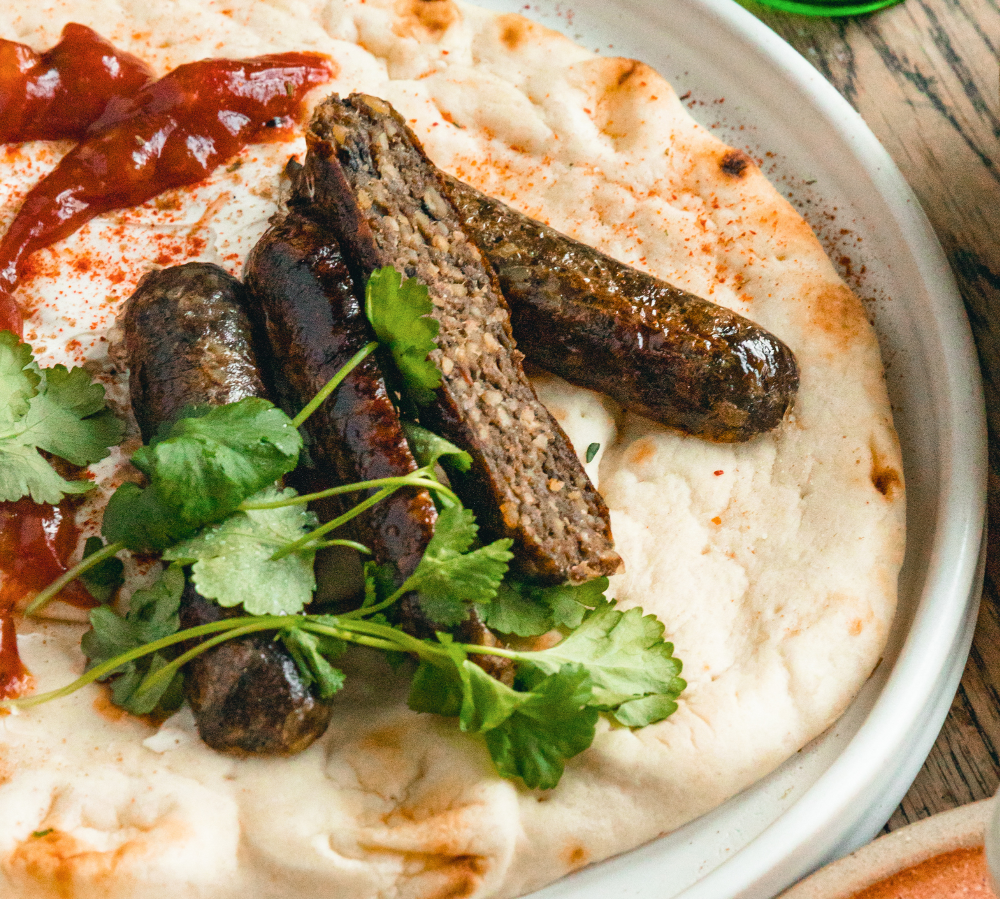Dishoom inspired spiced sausage naan roll.
